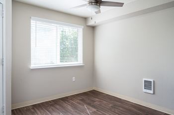a bedroom with a ceiling fan and a window